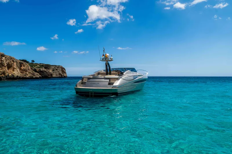 Vimojal II Yacht Photos Pics Luxurious 2009 Riva 52' LE yacht on clear turquoise waters under blue sky.