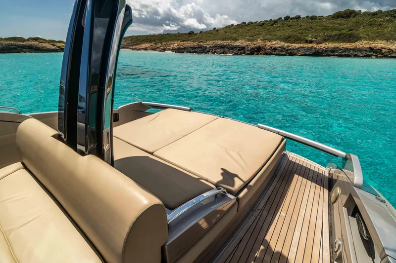 Vimojal II Yacht Photos Pics Luxurious 2009 Riva 52' LE yacht on turquoise waters, featuring elegant deck seating.