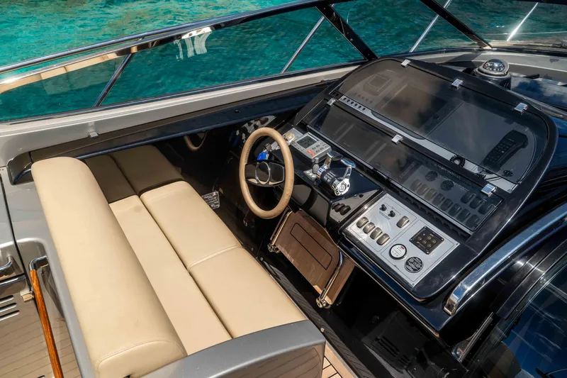 Vimojal II Yacht Photos Pics Luxurious 2009 Riva 52' le yacht cockpit with modern controls and beige seating.