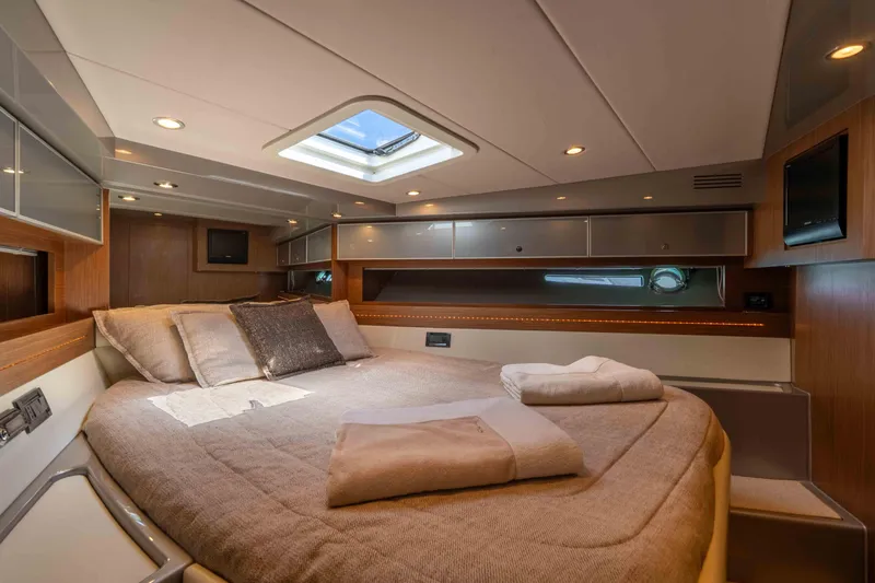 Vimojal II Yacht Photos Pics Luxurious cabin interior of a 2009 Riva 52' le yacht, featuring a cozy bed and modern design.