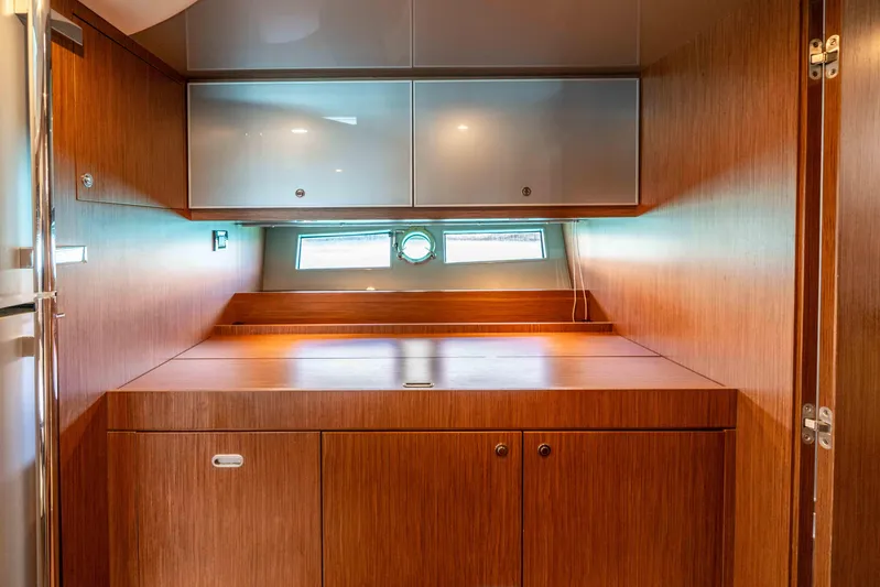 Vimojal II Yacht Photos Pics Interior of 2009 Riva 52' le yacht with wooden cabinetry and small windows.