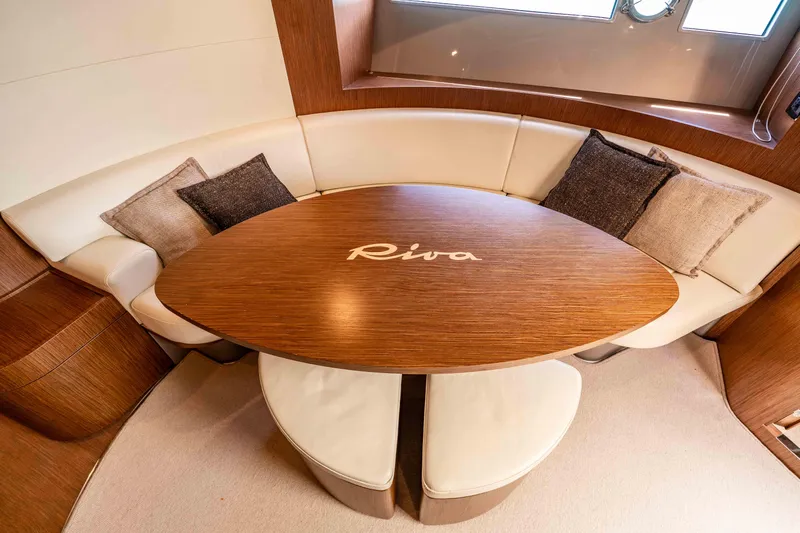 Vimojal II Yacht Photos Pics Luxurious interior of 2009 Riva 52' le yacht with elegant wood table and plush seating.