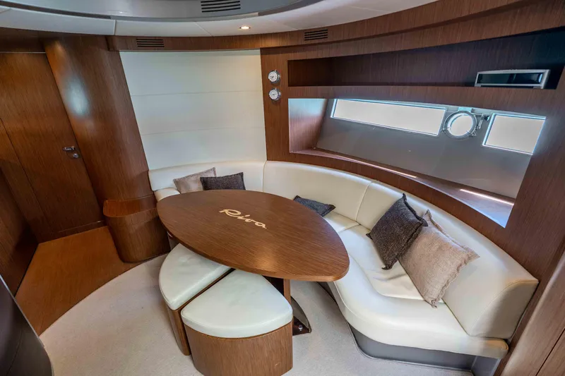 Vimojal II Yacht Photos Pics Luxurious interior of 2009 Riva 52' le yacht with elegant wood and leather seating.