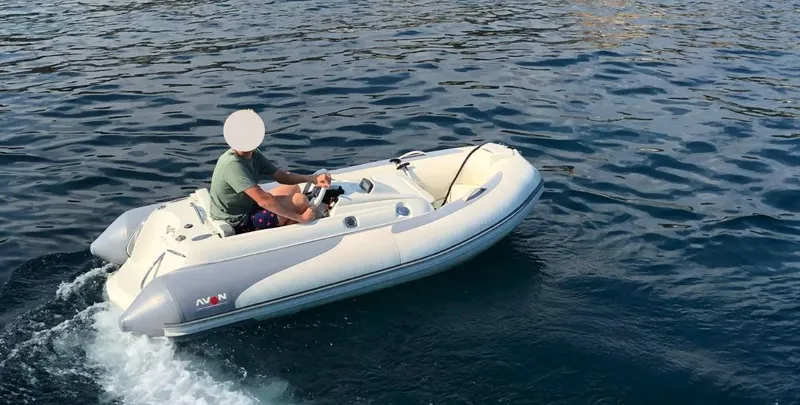 Vimojal II Yacht Photos Pics A person driving a small inflatable boat on the water.