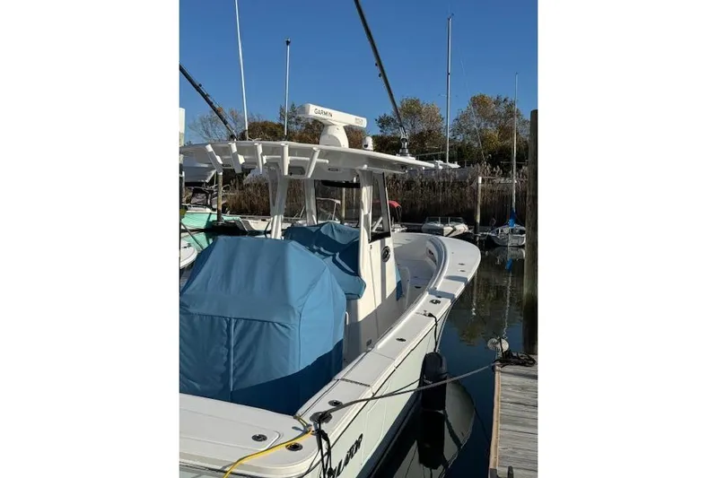  Yacht Photos Pics 2023 Regulator 31 boat docked, featuring a covered console and Garmin equipment.
