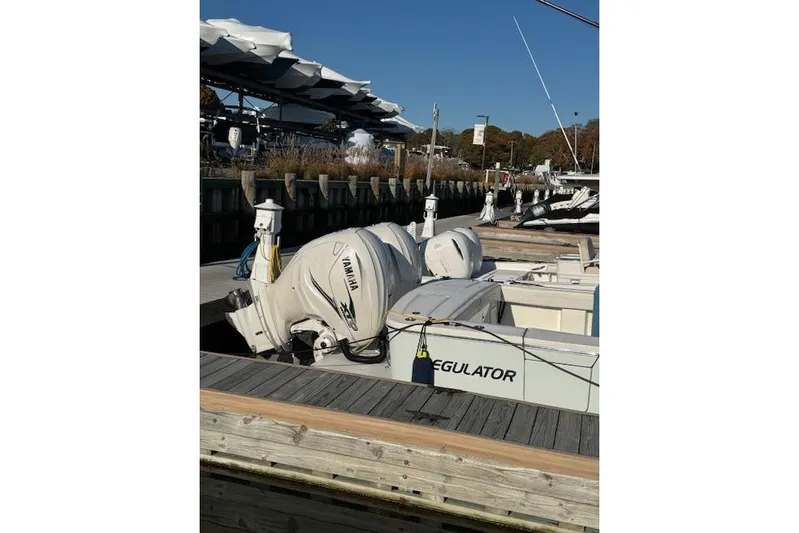  Yacht Photos Pics 2023 Regulator 31 boat docked with Yamaha engines, marina background.