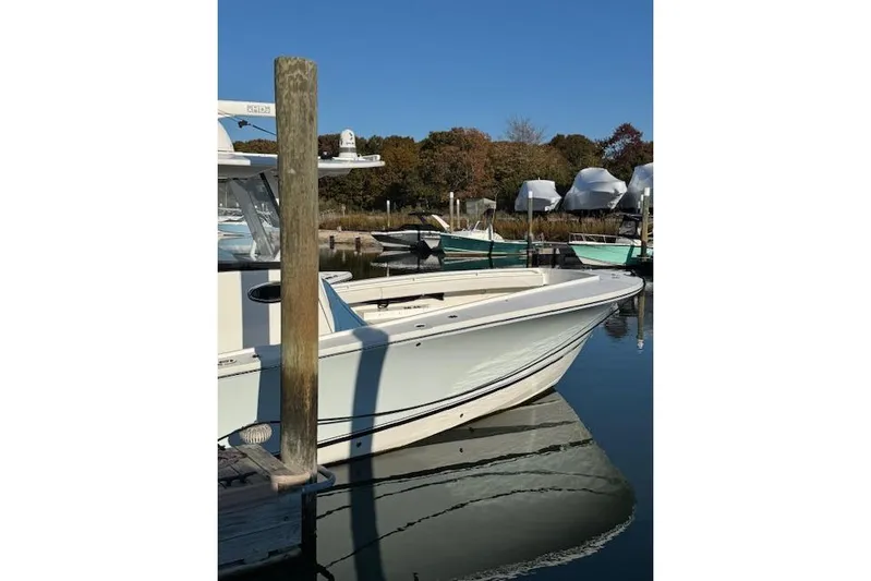  Yacht Photos Pics 2023 Regulator 31 boat docked in a serene marina setting.