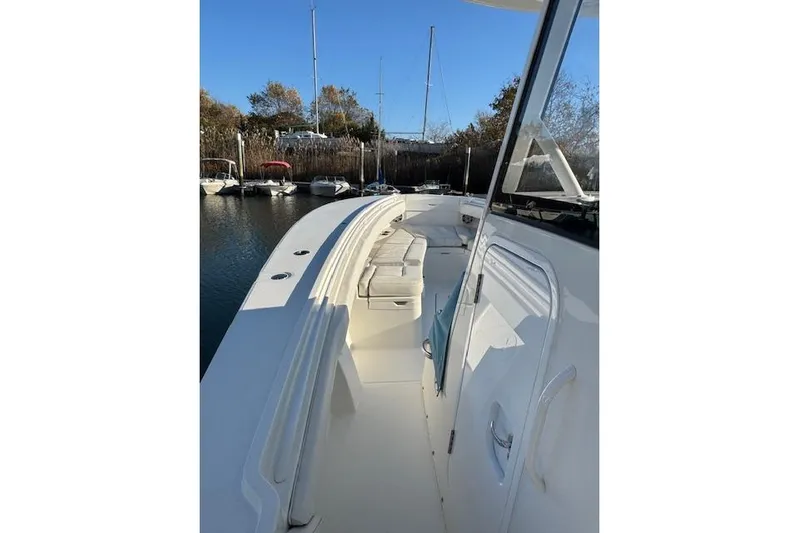  Yacht Photos Pics 2023 Regulator 31 boat docked, showcasing sleek design and spacious deck.