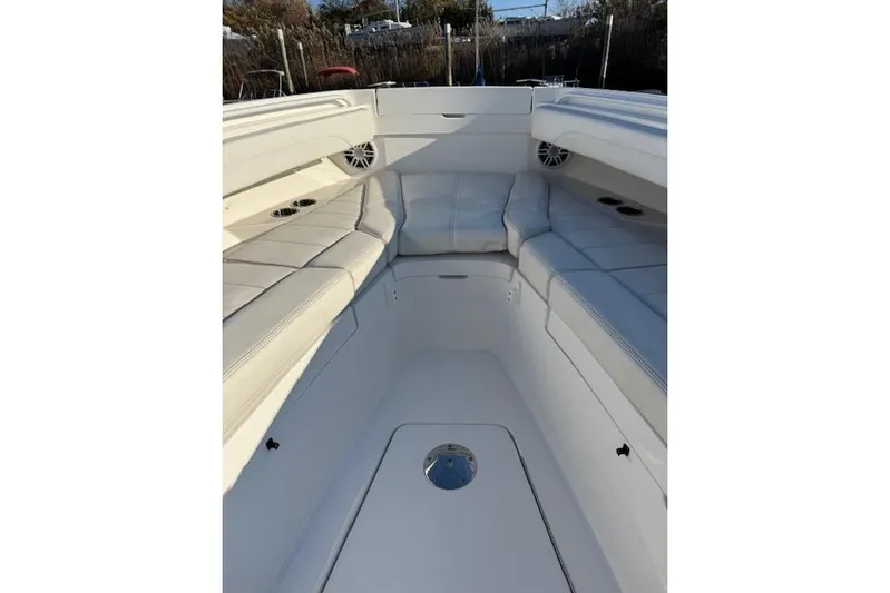  Yacht Photos Pics 2023 Regulator 31 boat interior with white cushioned seating and cup holders.
