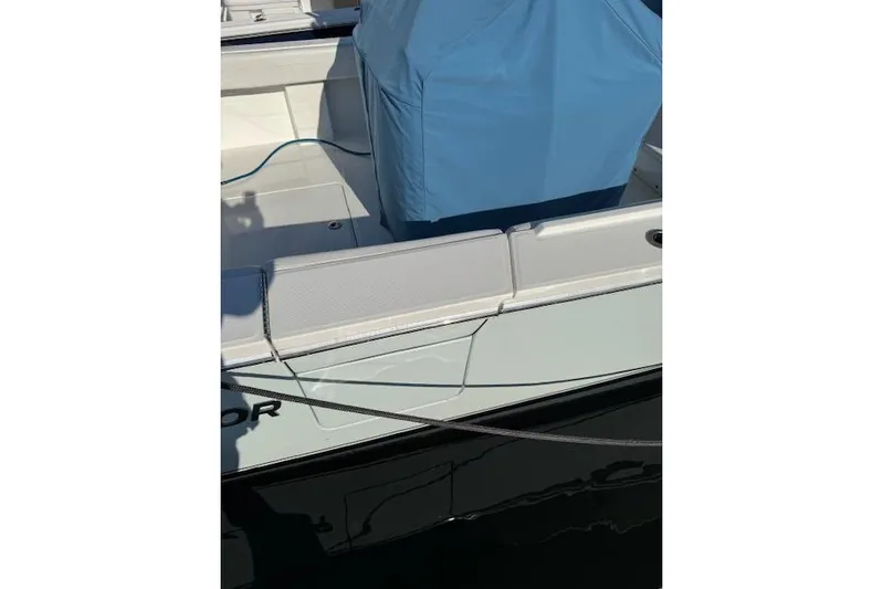  Yacht Photos Pics 2023 Regulator 31 boat deck with blue cover and visible branding.