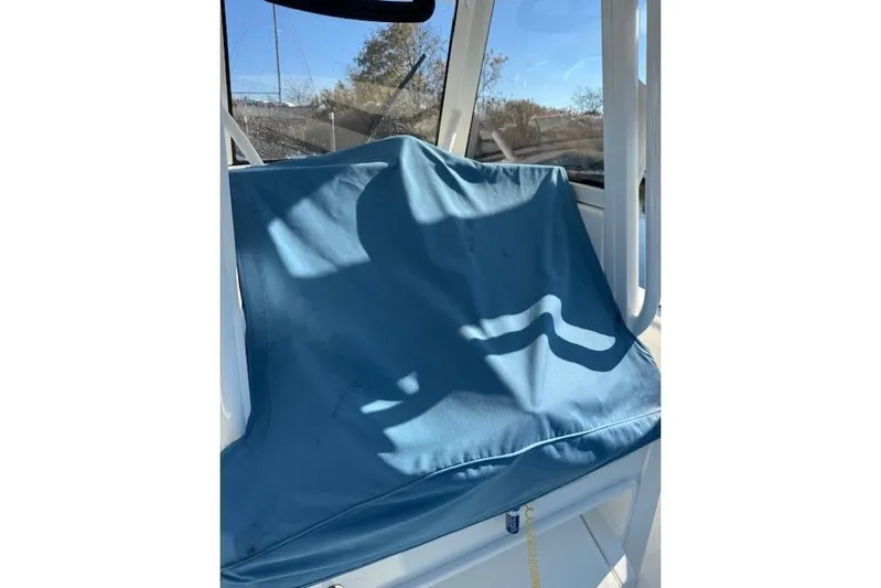  Yacht Photos Pics Blue seat cover on 2023 Regulator 31 boat, sunlight casting shadows.