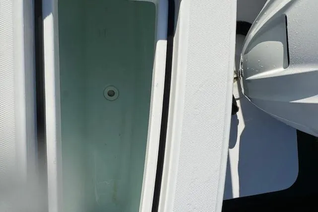  Yacht Photos Pics 2023 Regulator 31 boat deck with storage compartment and engine detail.