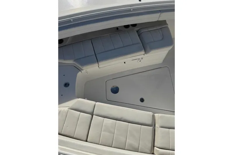  Yacht Photos Pics 2023 Regulator 31 boat interior with cushioned seating and storage compartments.