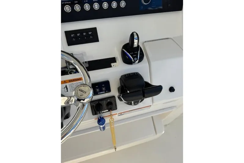  Yacht Photos Pics 2023 Regulator 31 boat dashboard with steering wheel and controls.
