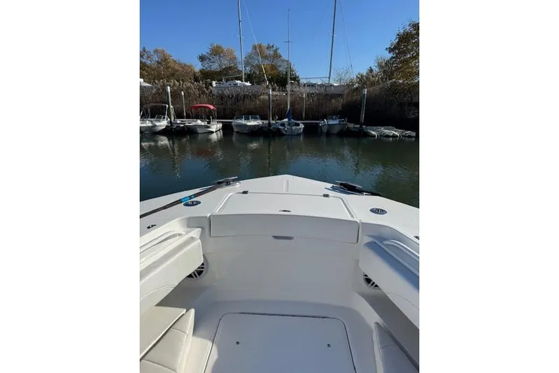  Yacht Photos Pics 2023 Regulator 31 boat docked, view from bow, surrounded by other boats.