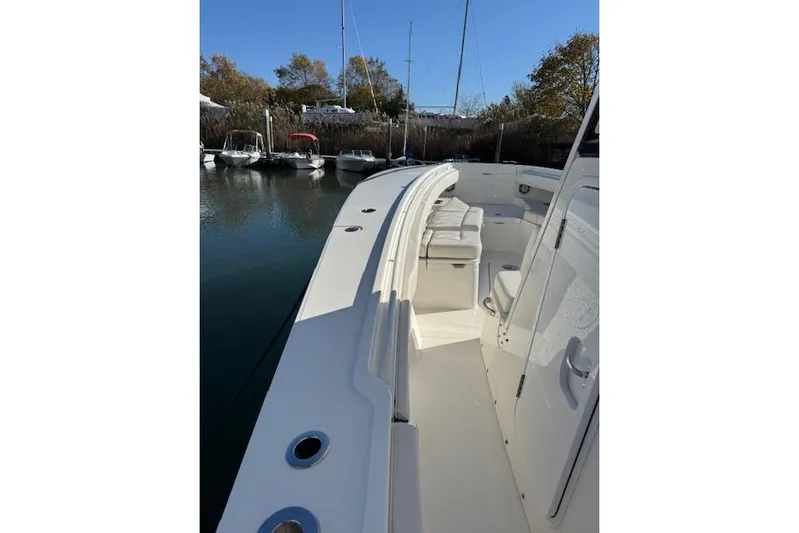  Yacht Photos Pics 2023 Regulator 31 boat docked, showcasing sleek design and spacious deck area.