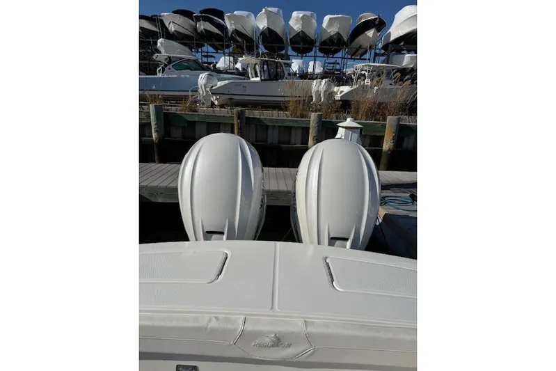  Yacht Photos Pics 2023 Regulator 31 boat with dual outboard engines docked at marina.