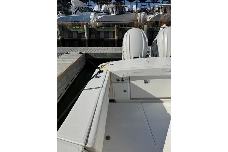  Yacht Photos Pics 2023 Regulator 31 boat docked, featuring dual outboard engines and spacious deck.