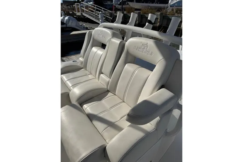  Yacht Photos Pics 2023 Regulator 31 boat seats, white leather, docked in marina.