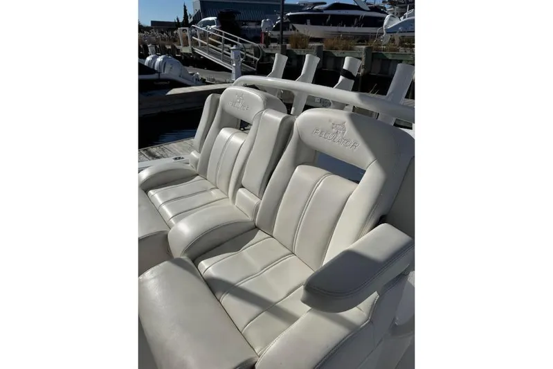  Yacht Photos Pics 2023 Regulator 31 boat seats, white leather, docked in marina.