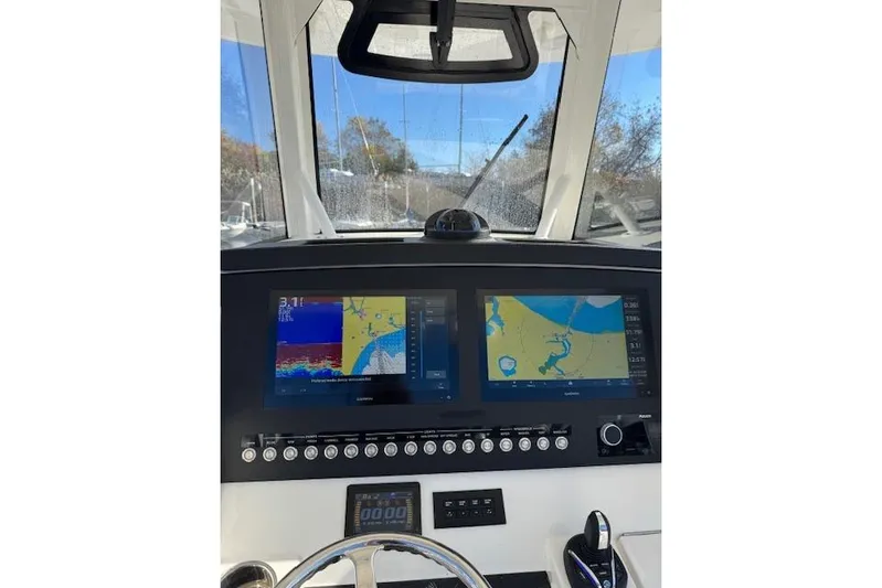  Yacht Photos Pics 2023 Regulator 31 boat dashboard with navigation screens and controls.