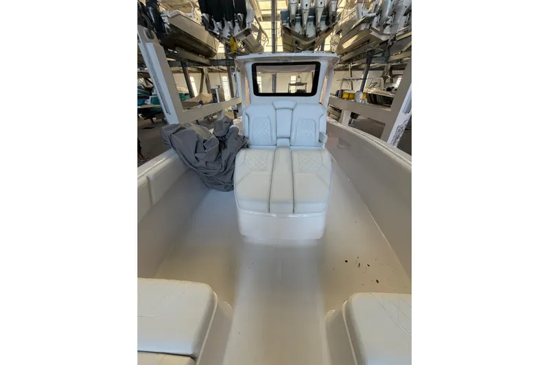  Yacht Photos Pics 2025 Deep Impact 369 Sport boat interior with white seating and storage area.