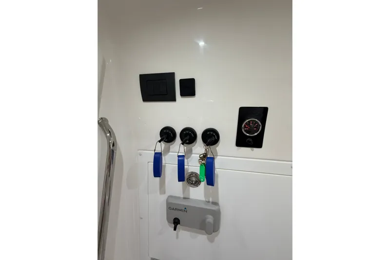  Yacht Photos Pics Control panel of 2025 Deep Impact 369 Sport boat with keys and Garmin device.