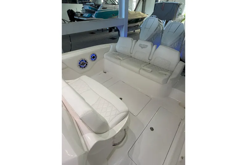  Yacht Photos Pics 2025 Deep Impact 369 Sport boat interior with white seating and speakers.