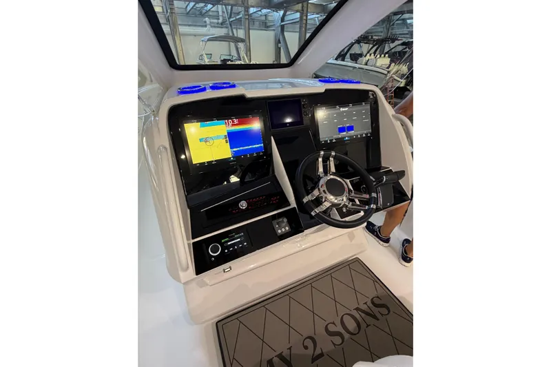  Yacht Photos Pics 2025 Deep Impact 369 Sport boat dashboard with advanced navigation displays and steering wheel.