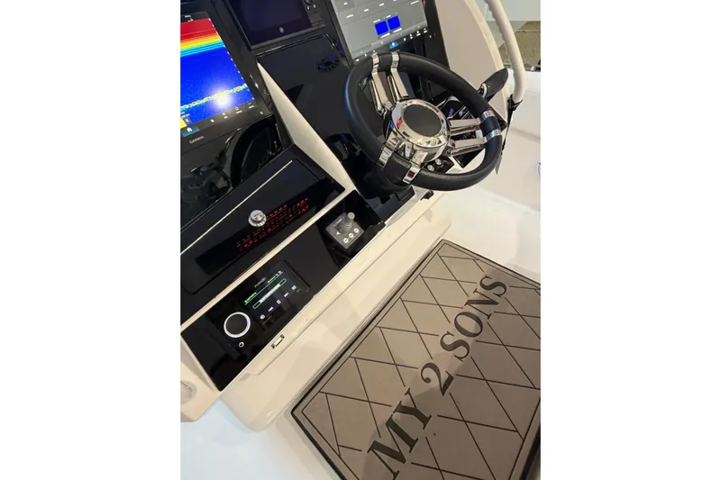  Yacht Photos Pics 2025 Deep Impact 369 Sport boat dashboard with steering wheel and "MY 2 SONS" mat.