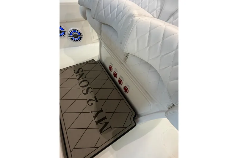  Yacht Photos Pics Luxurious white seating in 2025 Deep Impact 369 Sport boat interior, featuring custom mat design.