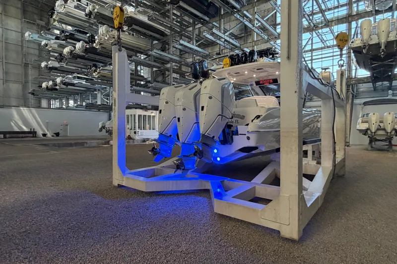  Yacht Photos Pics 2025 Deep Impact 369 Sport boat in storage facility with blue lighting.