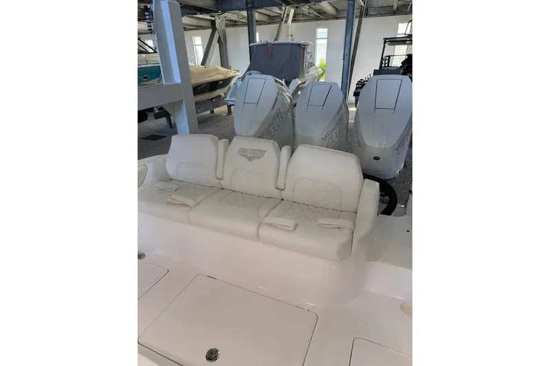  Yacht Photos Pics 2025 Deep Impact 369 Sport boat with triple engines and white seating in a showroom.