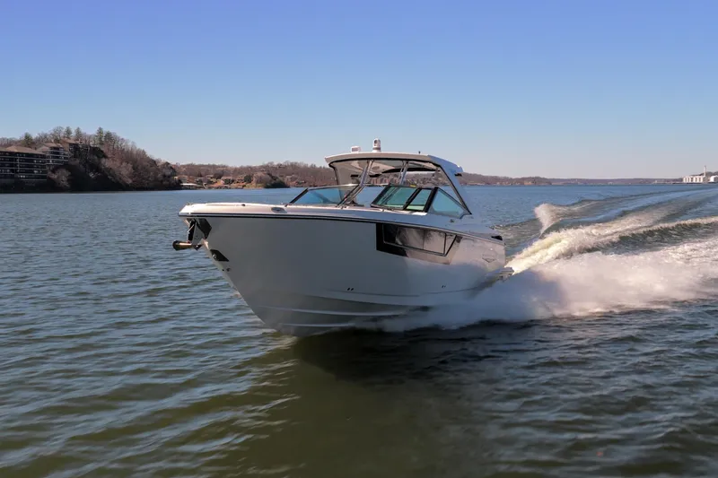 Yacht Photos Pics 2026 Monterey 378SS Super Sport cruising on a scenic lake under clear blue skies.