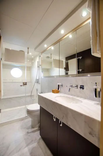  Yacht Photos Pics Luxurious bathroom in 2018 Sunseeker 75 Yacht with modern fixtures and marble finishes.