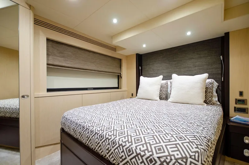  Yacht Photos Pics Luxurious bedroom interior of 2018 Sunseeker 75 Yacht with modern decor and comfortable bedding.