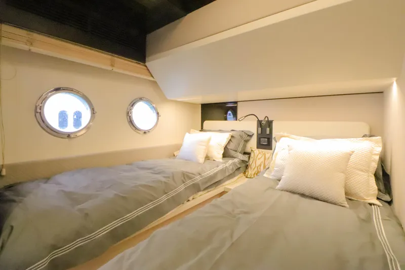  Yacht Photos Pics Interior of 2019 Azimut 66 yacht with twin beds and portholes.