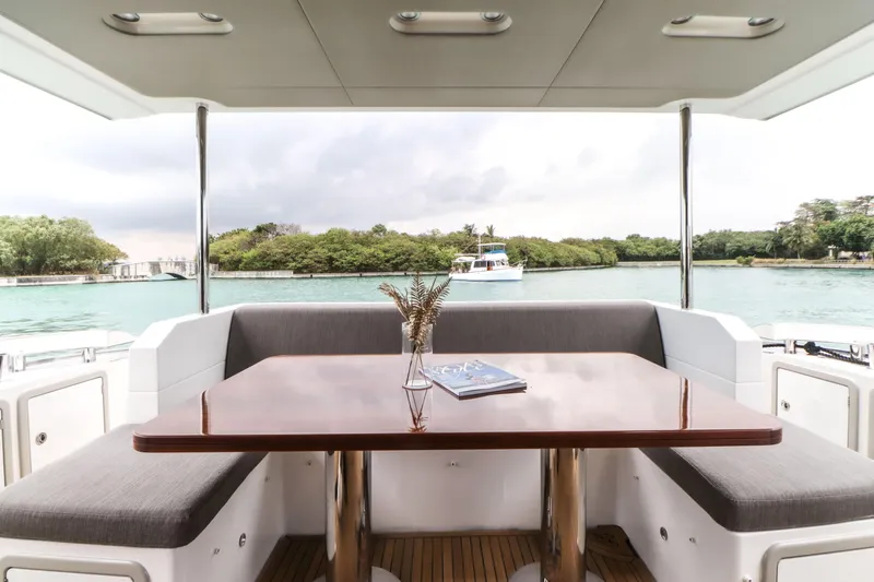  Yacht Photos Pics Interior view of 2019 Azimut 66 yacht with table and seating area.