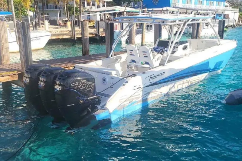  Yacht Photos Pics 2016 Extreme Boats 38 with triple 400 horsepower engines docked in clear blue water.