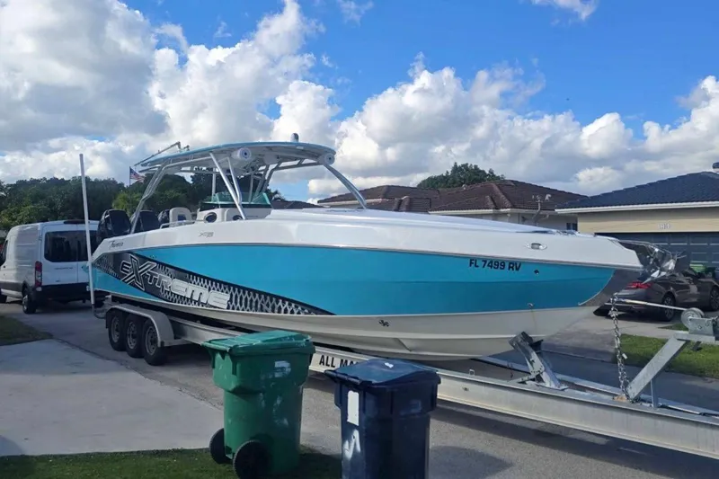  Yacht Photos Pics 2016 Extreme Boats 38 on trailer, parked in residential driveway under blue sky.