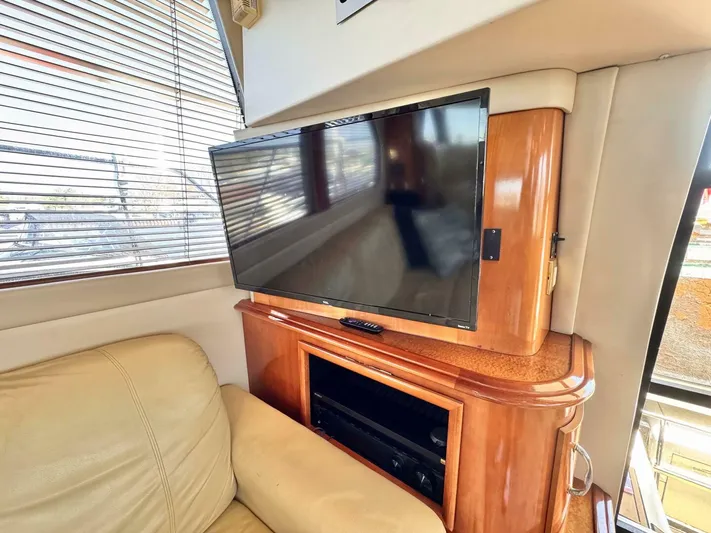  Yacht Photos Pics Interior of 2004 Carver 460 Voyager with TV and wooden cabinetry.