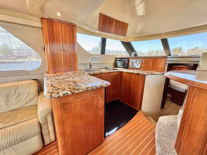  Yacht Photos Pics Luxurious 2004 Carver 460 Voyager yacht interior with elegant wood cabinetry and granite countertops.