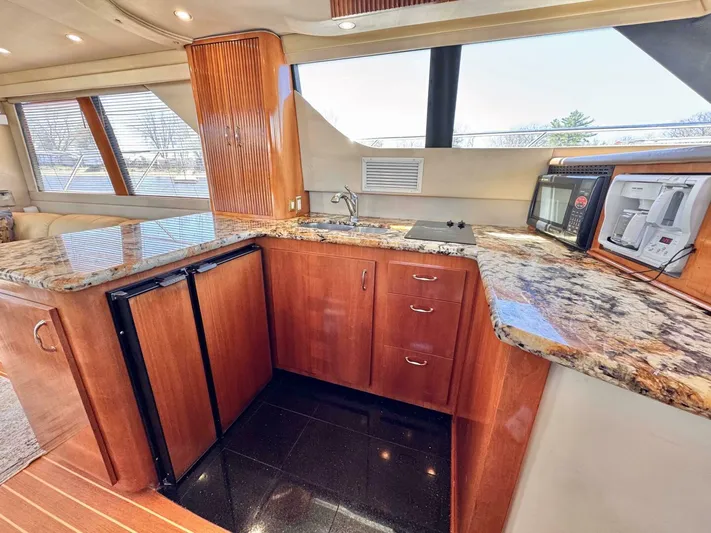 Yacht Photos Pics Luxurious 2004 Carver 460 Voyager yacht kitchen with granite countertops and modern appliances.