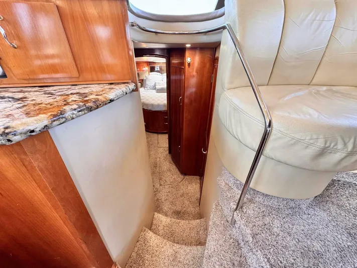  Yacht Photos Pics Interior of 2004 Carver 460 Voyager yacht with stairs, leather seating, and wood cabinetry.