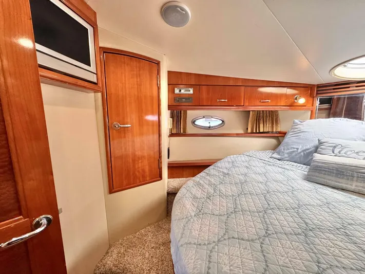 Yacht Photos Pics Luxurious cabin interior of 2004 Carver 460 Voyager yacht with wood finishes and cozy bedding.