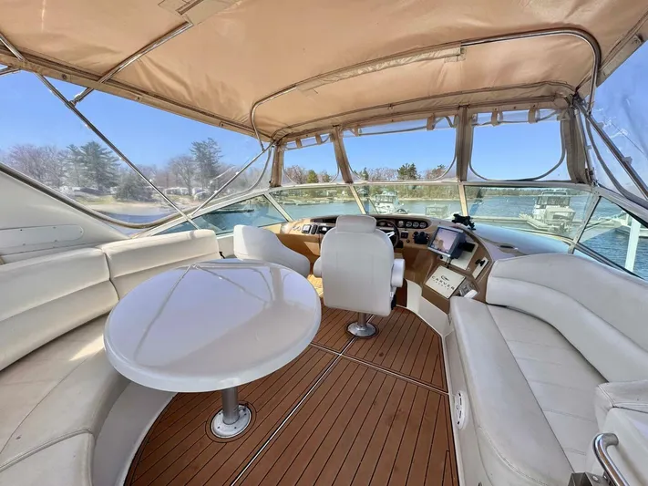  Yacht Photos Pics 2004 Carver 460 Voyager yacht interior with seating, table, and helm station.