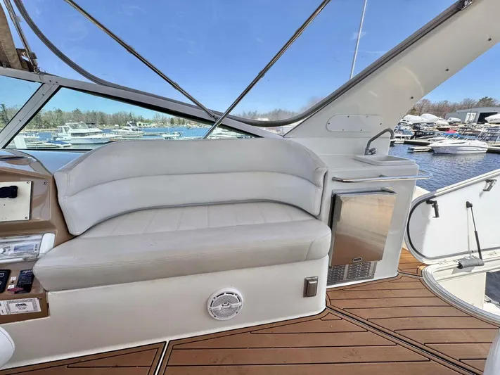  Yacht Photos Pics 2004 Carver 460 Voyager yacht interior with white seating and mini fridge, docked at marina.