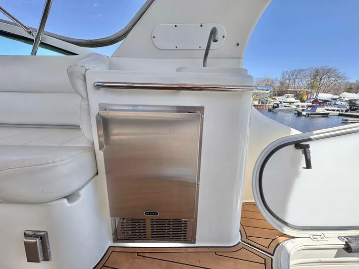  Yacht Photos Pics 2004 Carver 460 Voyager yacht interior with stainless steel fridge and white seating.