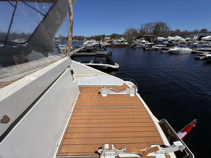  Yacht Photos Pics 2004 Carver 460 Voyager yacht docked at marina, featuring spacious deck and clear blue sky.