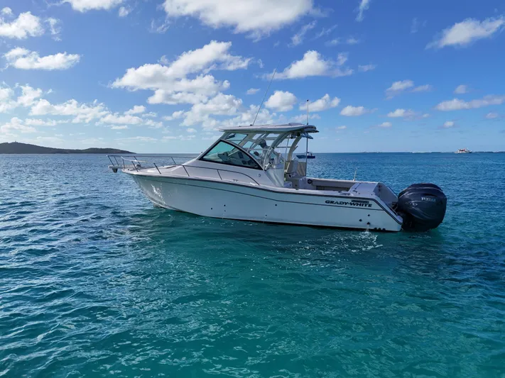  Yacht Photos Pics 2021 Grady-White Express 330 boat on clear blue water under a sunny sky.